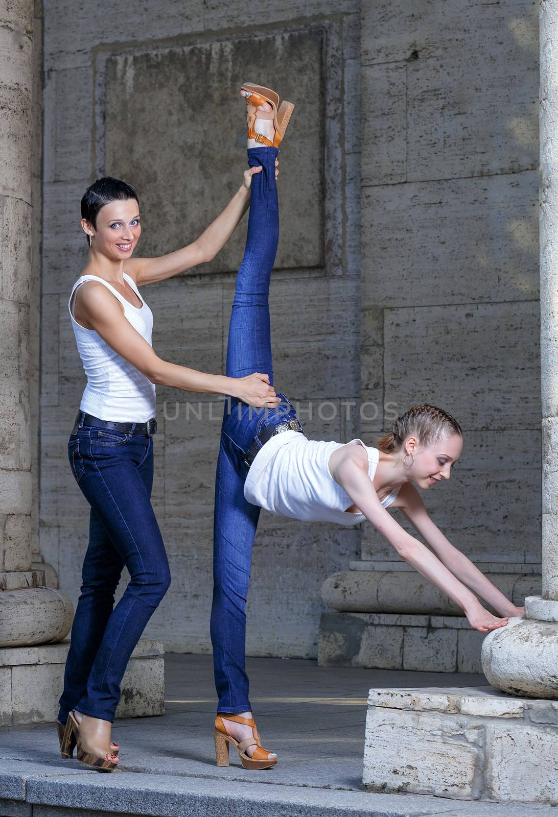 Family, mother helping her daughter to stretch