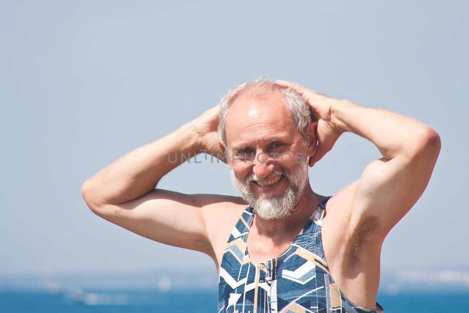 Elderly man on the background of the sea