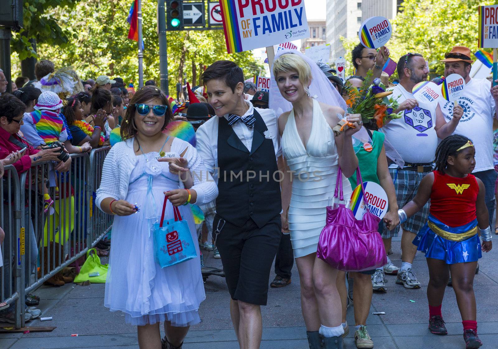 SAN FRANCISCO -  JUNE 30 : An unidentified Lesbian couple with there daughter participates at the annual San Francisco Gay pride parade on June 30 2013