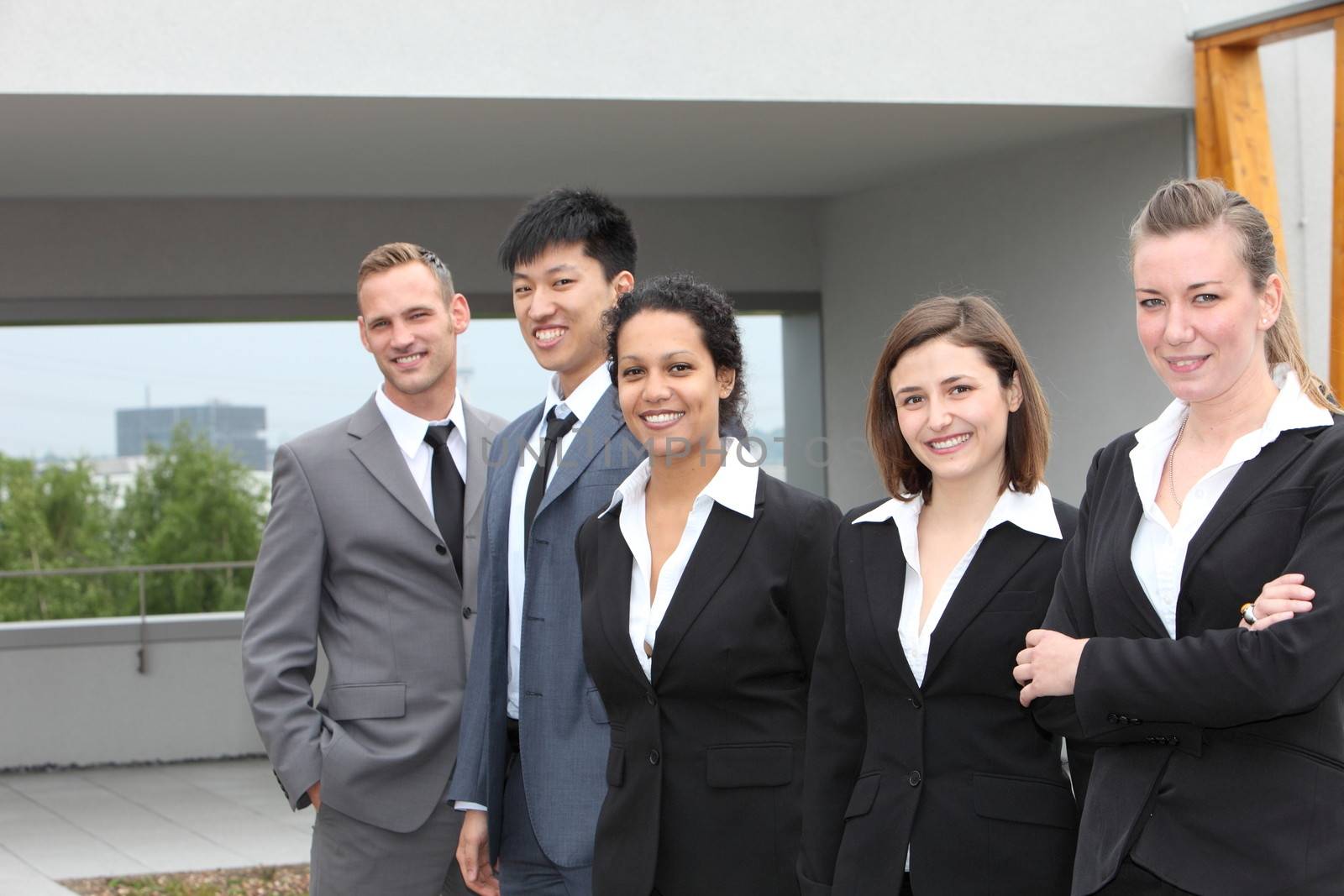 Confident business team standing together outdoors by Farina6000