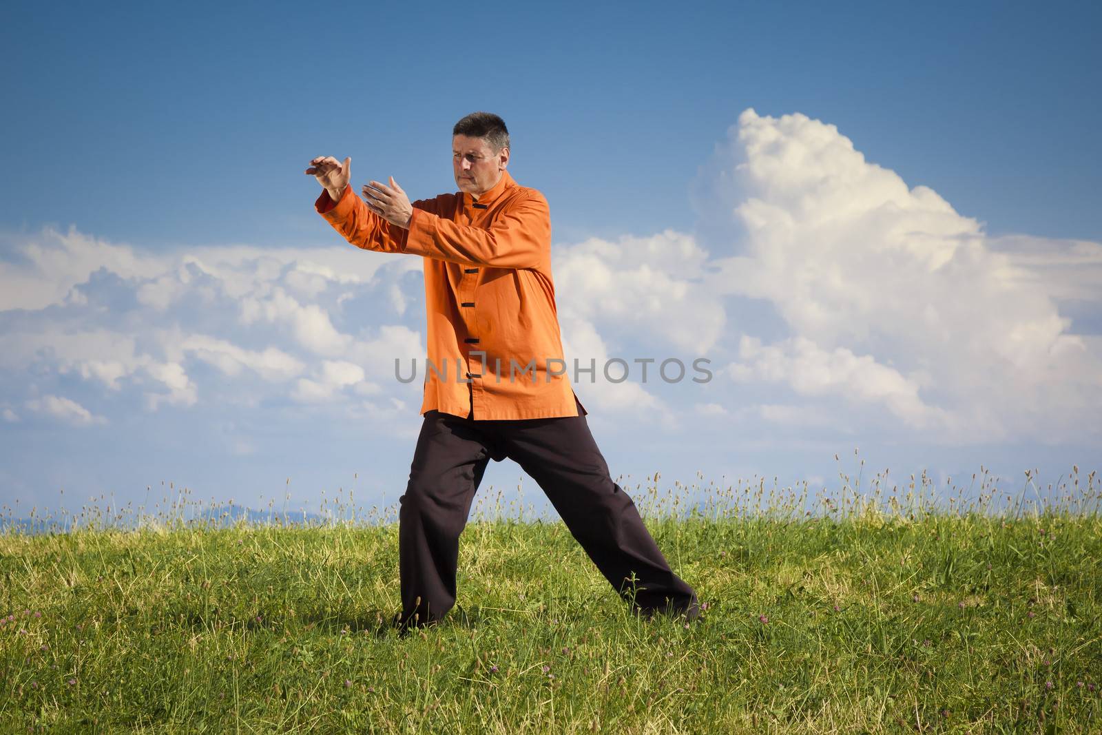 A man doing Qi-Gong in the green nature