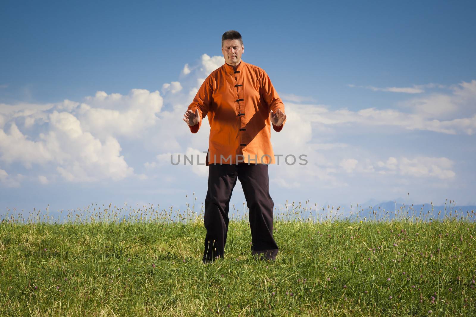 A man doing Qi-Gong in the green nature