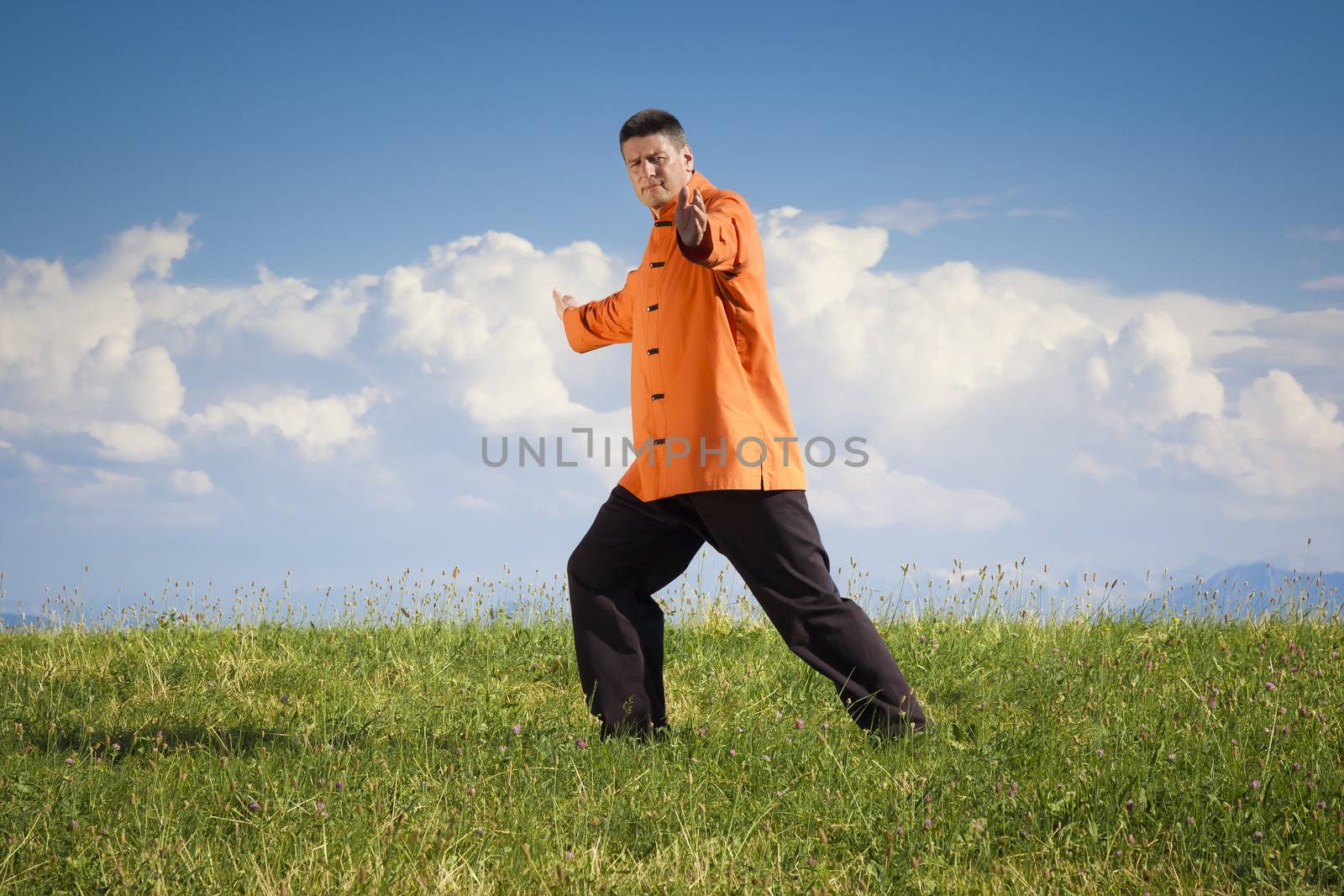 A man doing Qi-Gong in the green nature