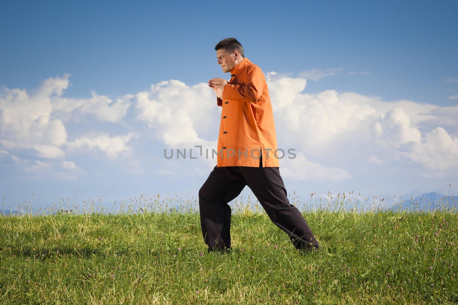 A man doing Qi-Gong in the green nature