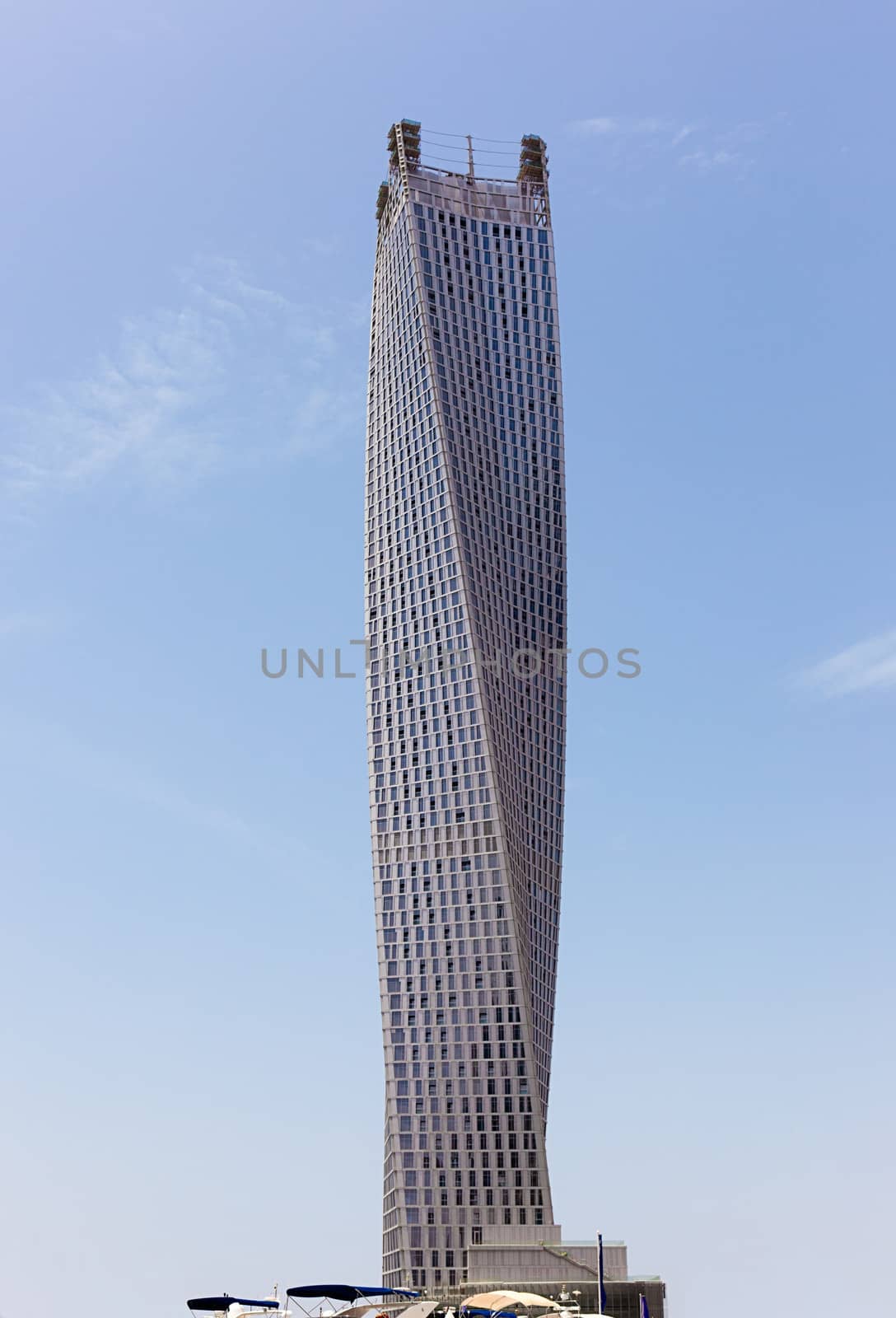 The world's tallest twisted tower in Dubai. Located by Dubai Marina, the 75-storey building rises to a height of 1,010ft (307 metres) and houses 495 apartments. The swerve of the structure will mean residents in the lower part of the tower will find their view oriented towards the waterfront promenade of Dubai Marina; those on the upper floors are rotated to face the Persian Gulf.