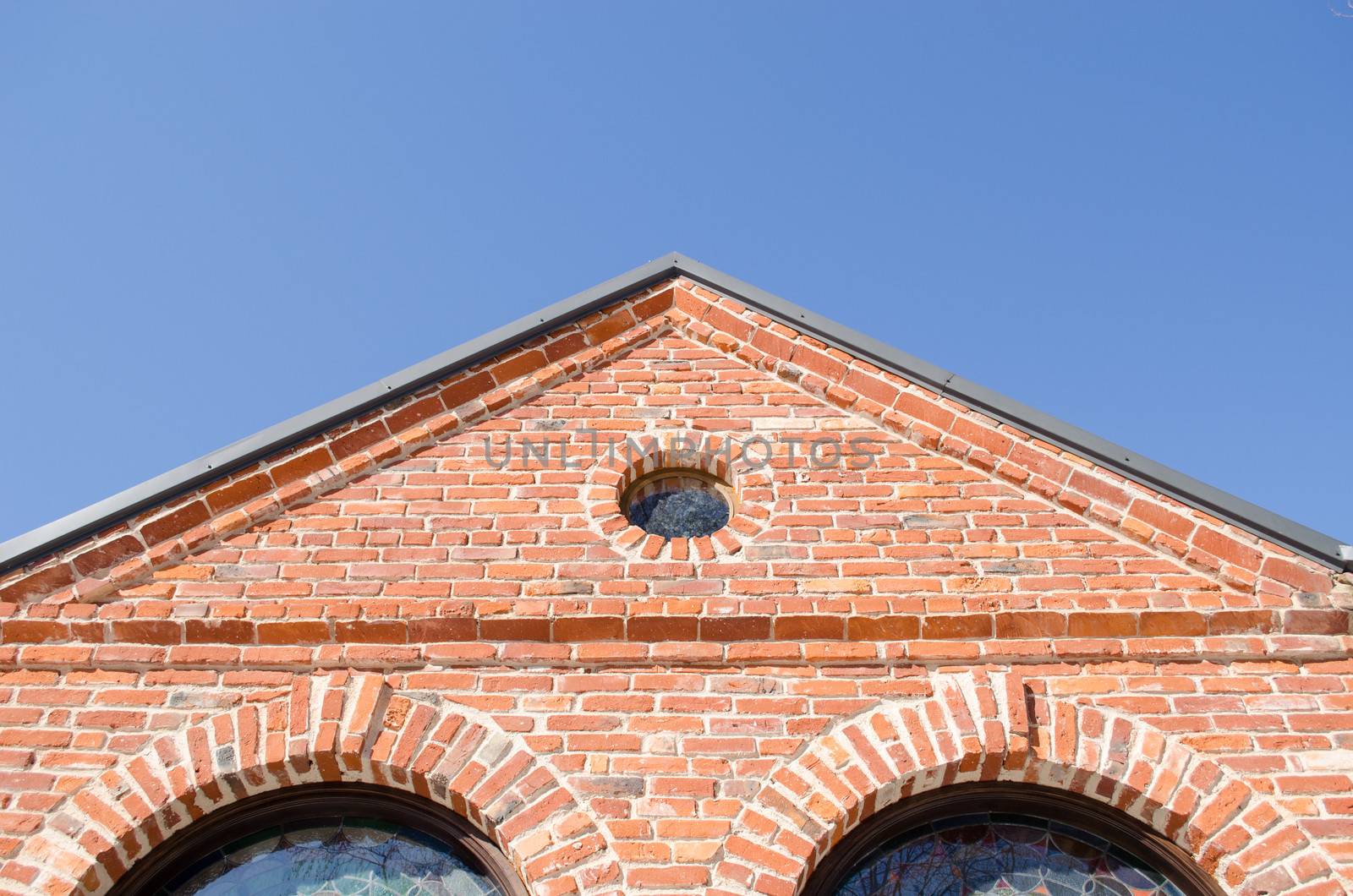 round window arch retro brick house roof blue sky by sauletas