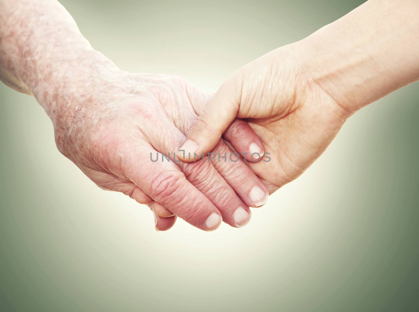 Senior Woman Holding Hands with a Young Lady on a green vintage background