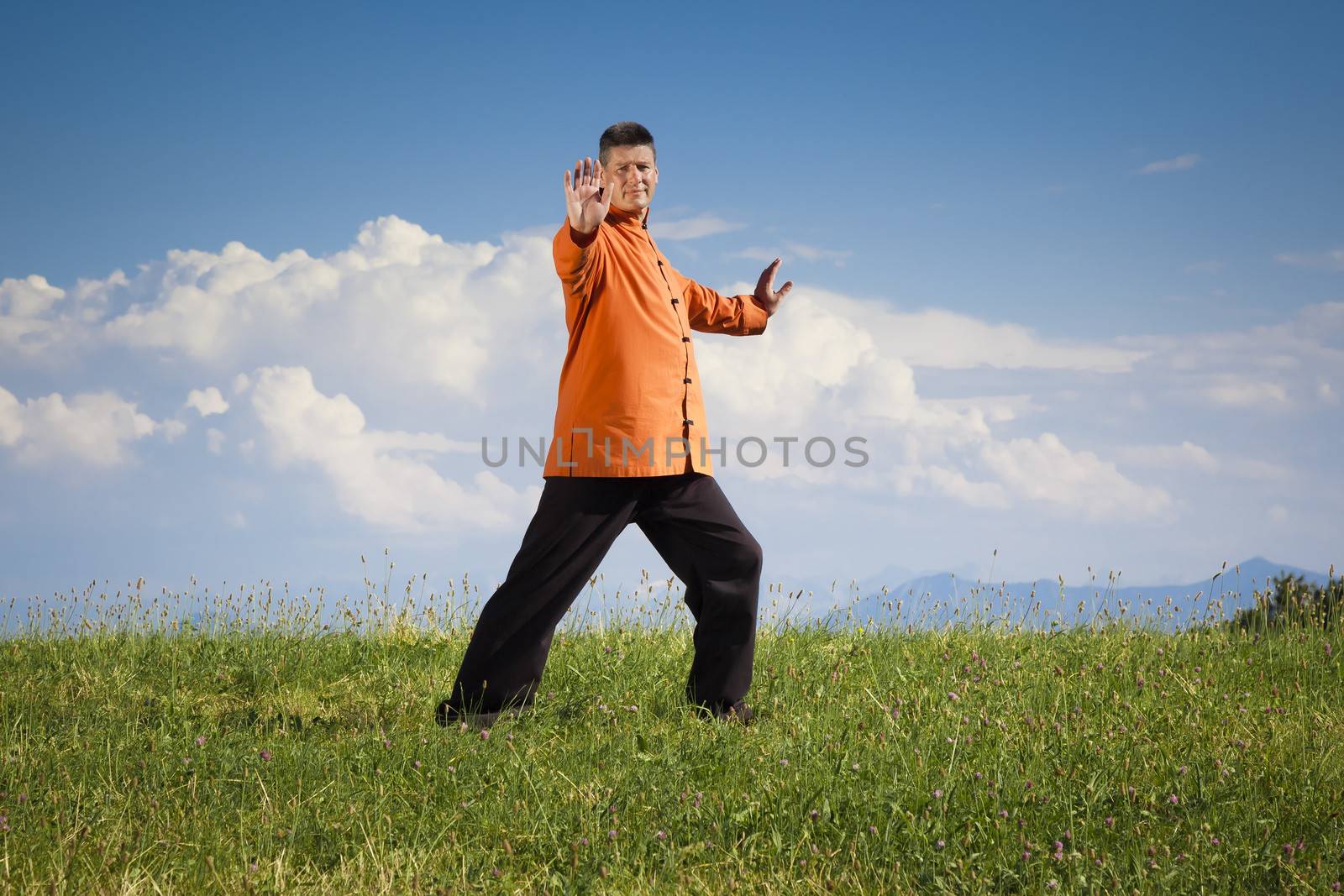 A man doing Qi-Gong in the green nature