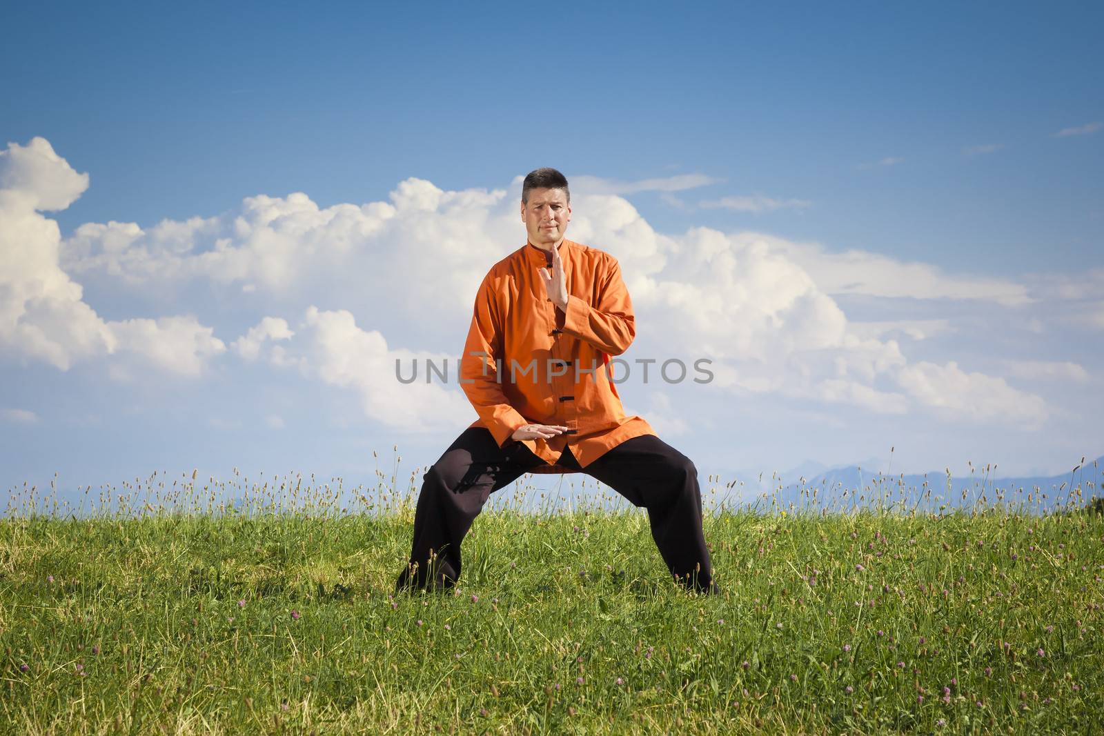 A man doing Qi-Gong in the green nature