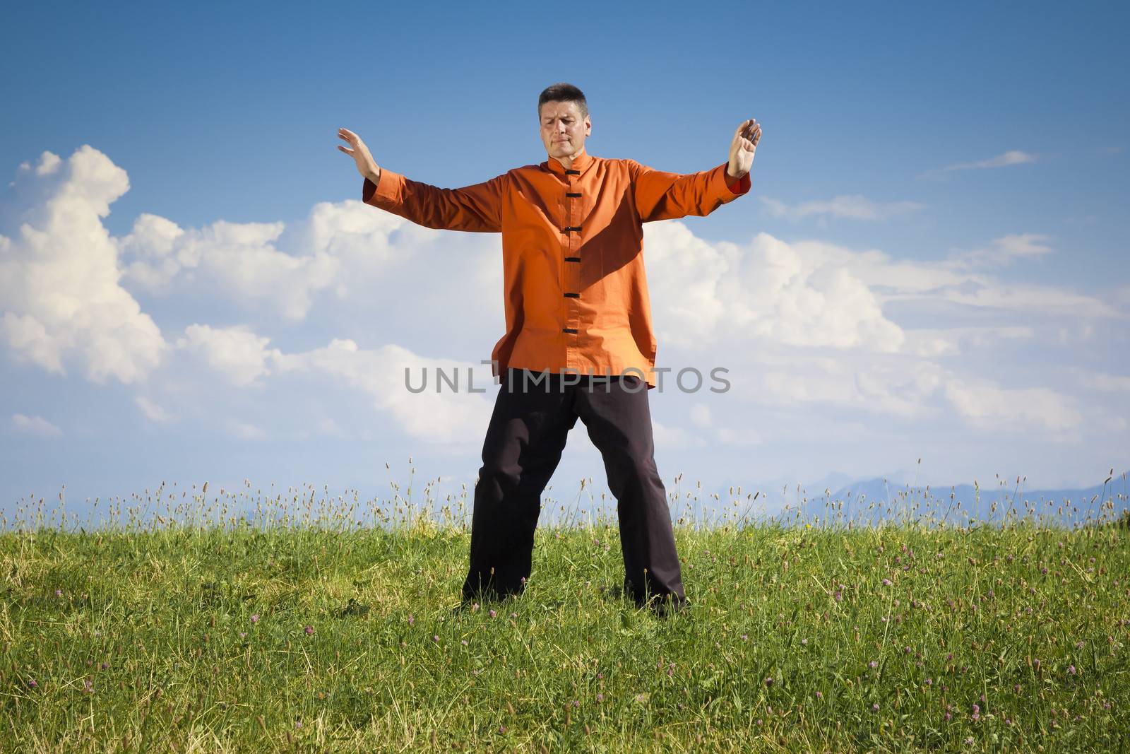 A man doing Qi-Gong in the green nature