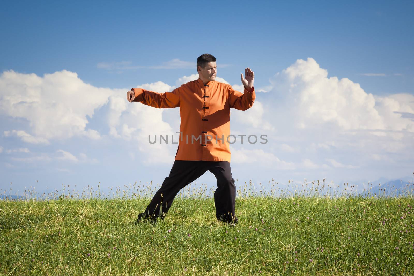 A man doing Qi-Gong in the green nature