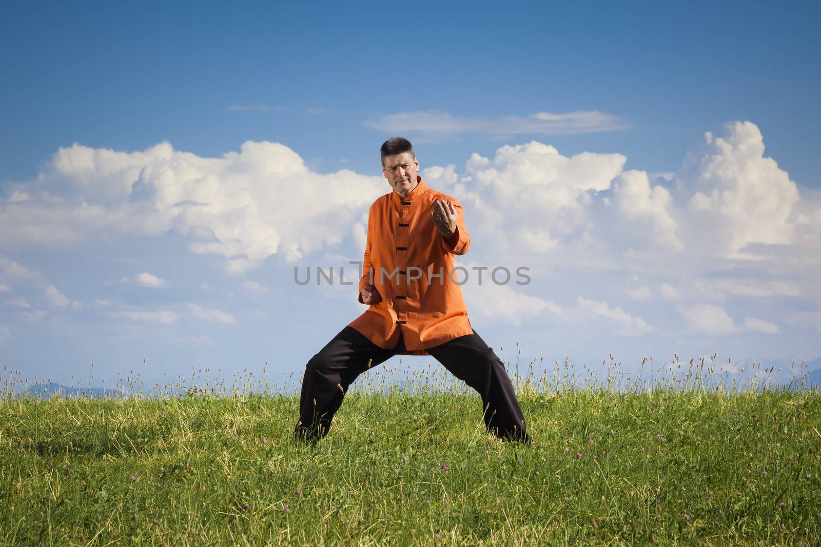 A man doing Qi-Gong in the green nature