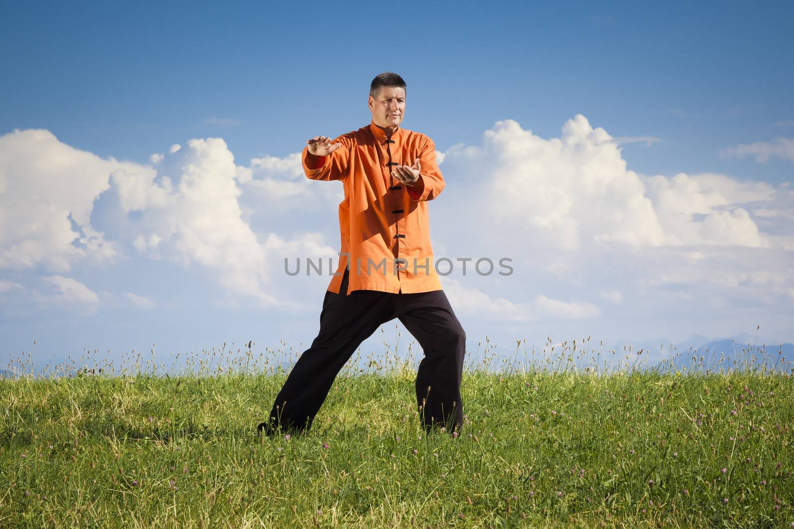 A man doing Qi-Gong in the green nature