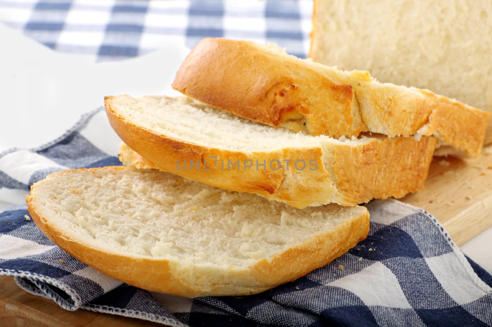 Fresh crusty bread just sliced and ready to serve.