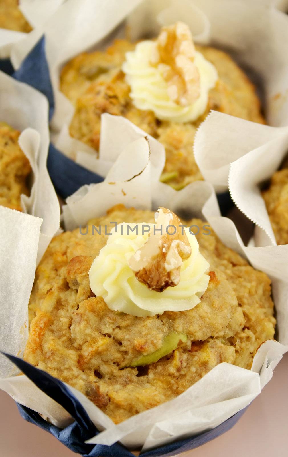Homestyle fresh baked fruit muffins with cream cheese and walnuts.