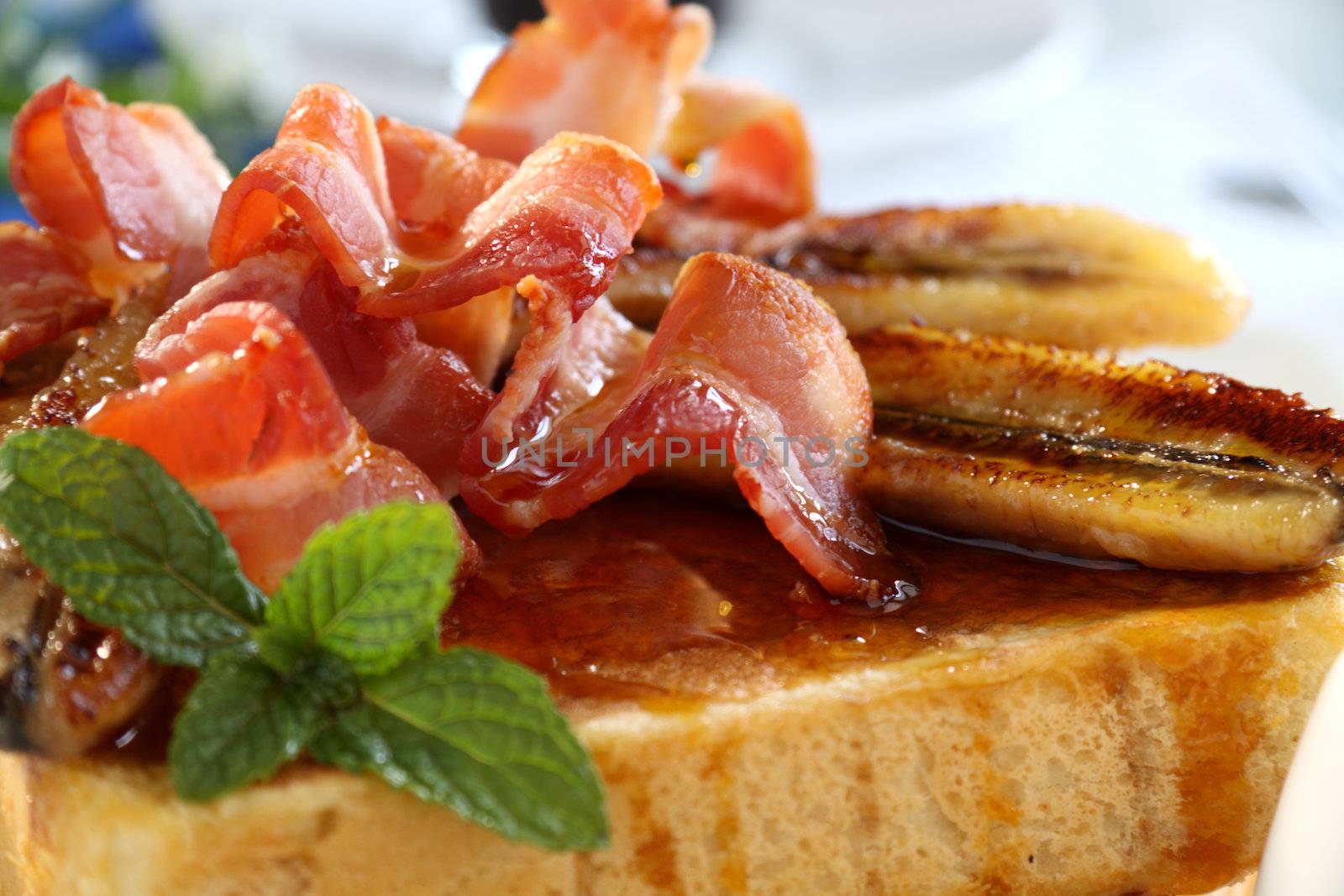 French toast with bacon and caramalized banana with maple syrup.