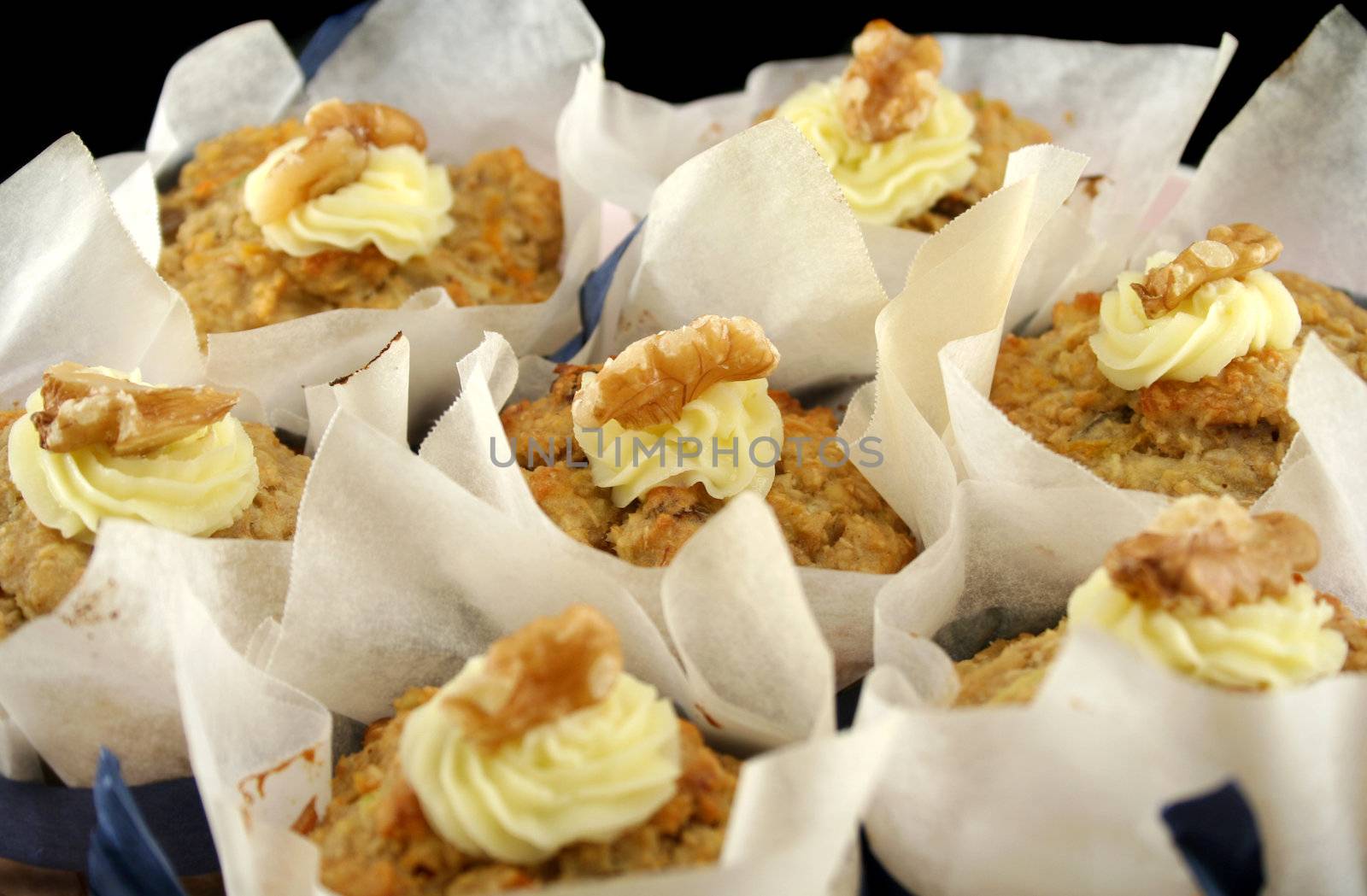 Homestyle fresh baked fruit muffins with cream cheese and walnuts.