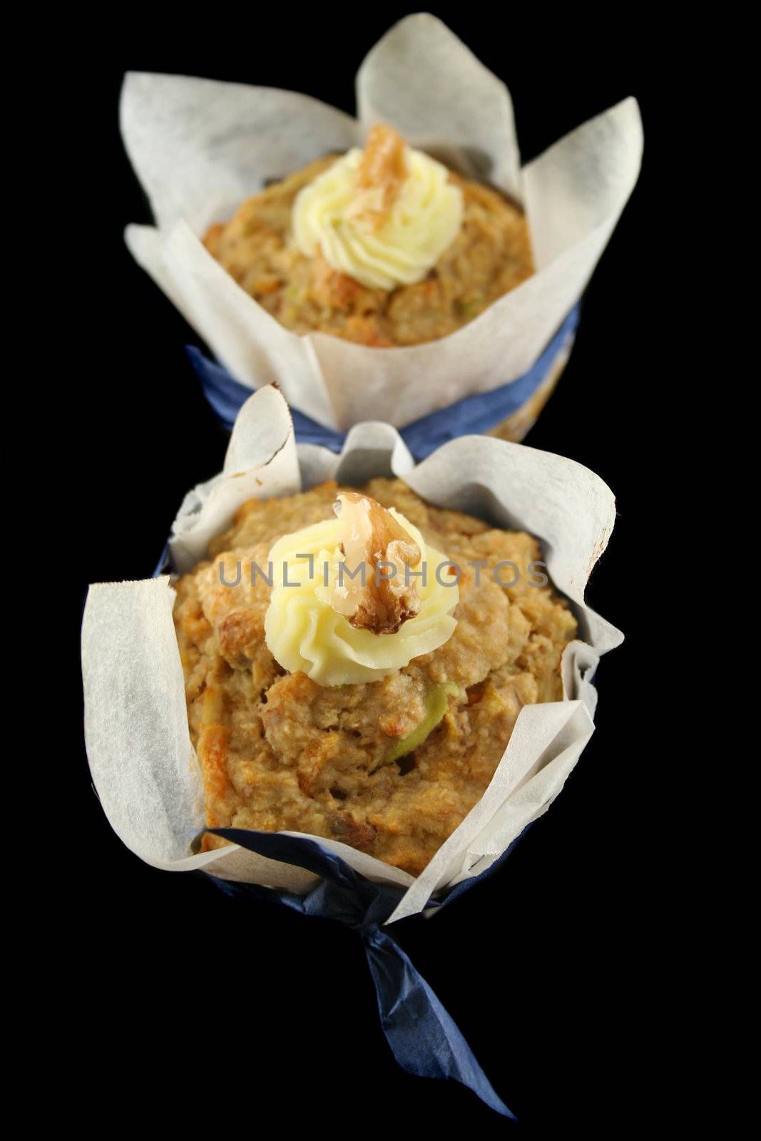 Homestyle fresh baked fruit muffins with cream cheese and walnuts.