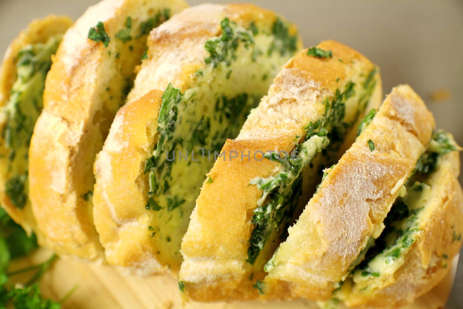 Fresh baked sliced herb and garlic roll from the oven.