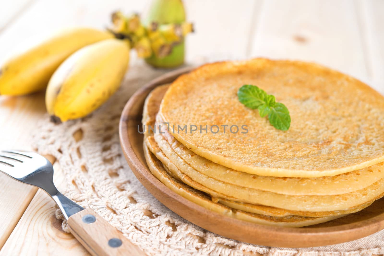 Banana pancakes or crepe on dining table.