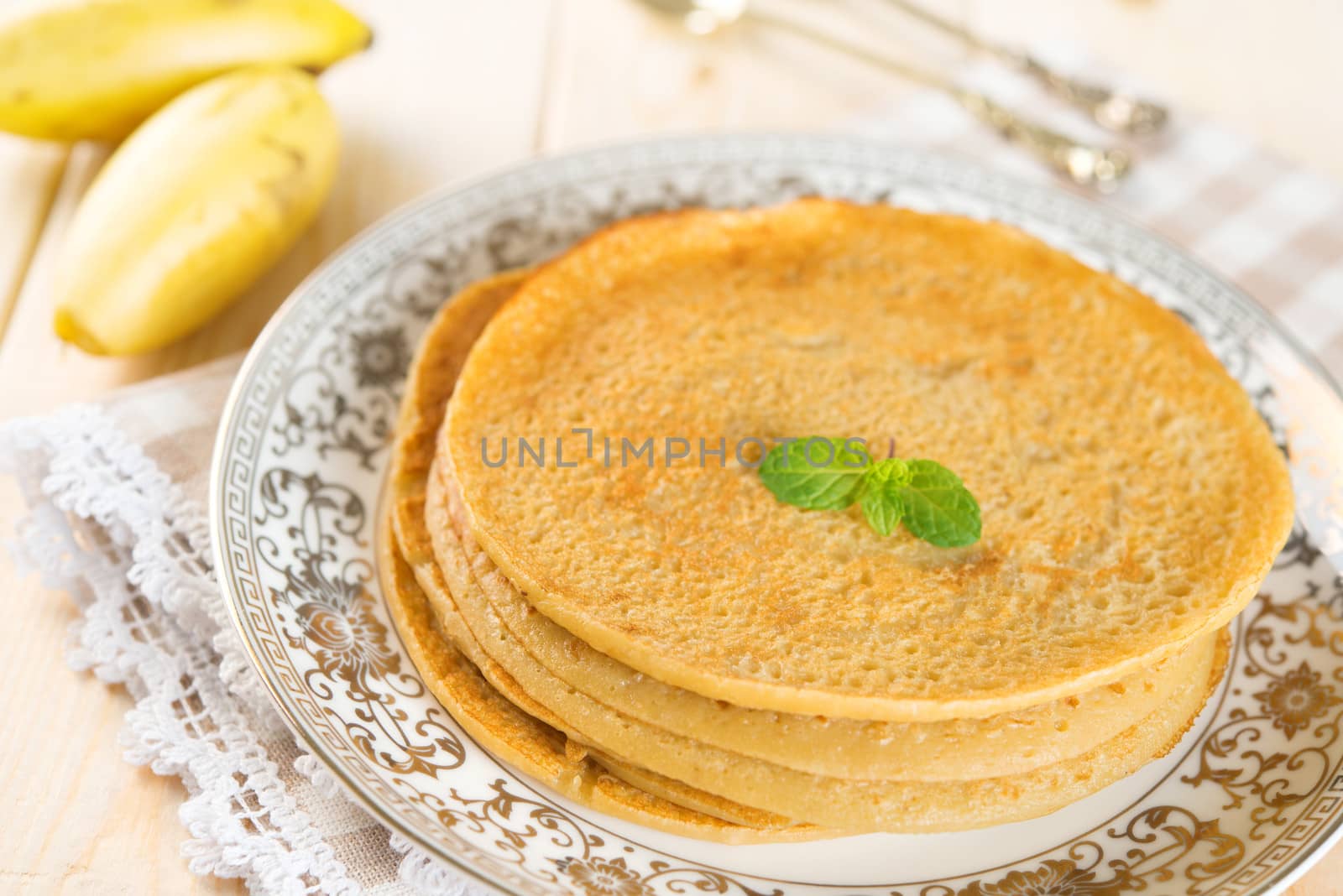 Delicious Asian style breakfast homemade banana pancakes or crepe on dining table.