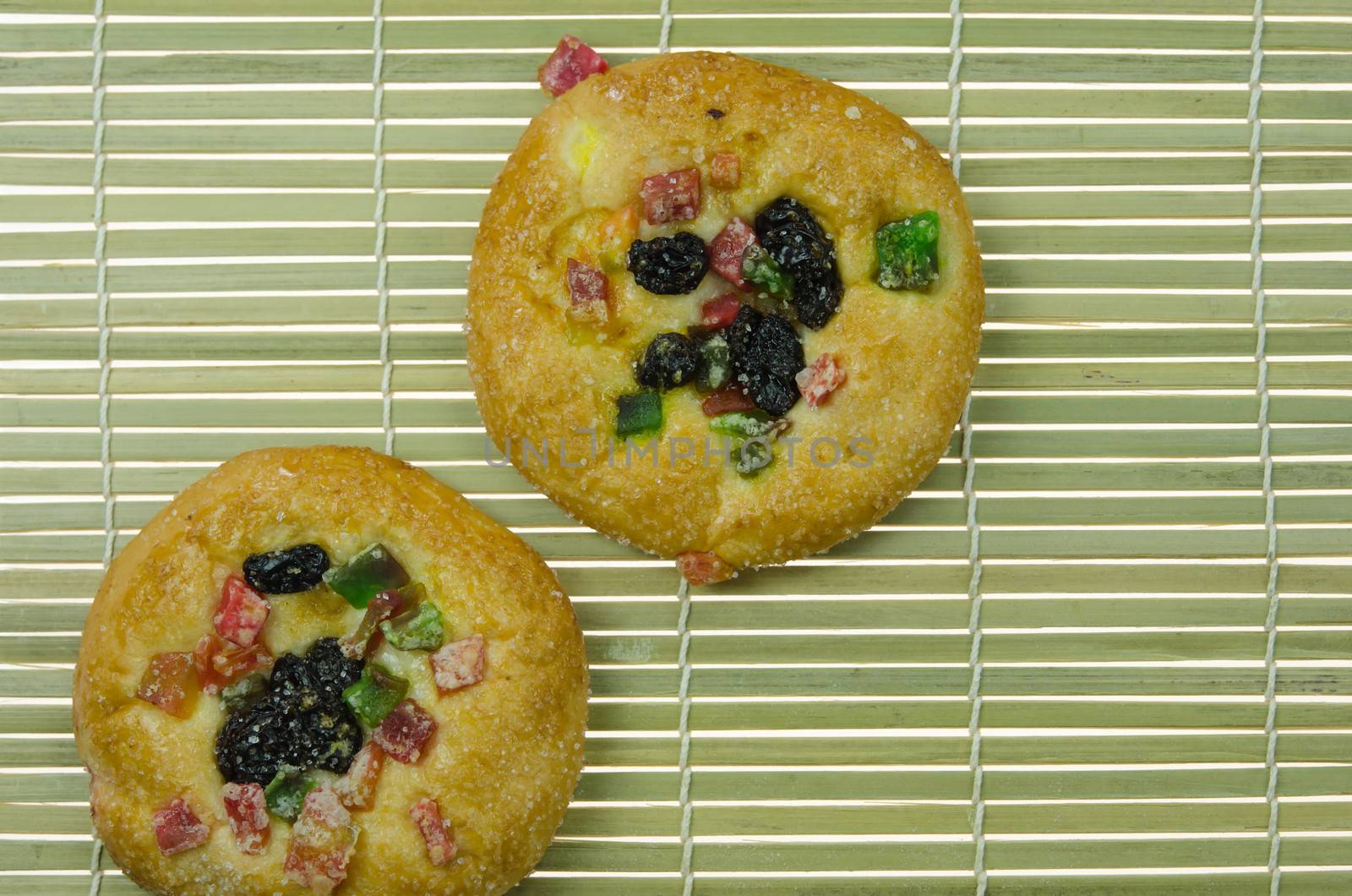 top view of  bread with raisin and  dried fruits on wooden background 