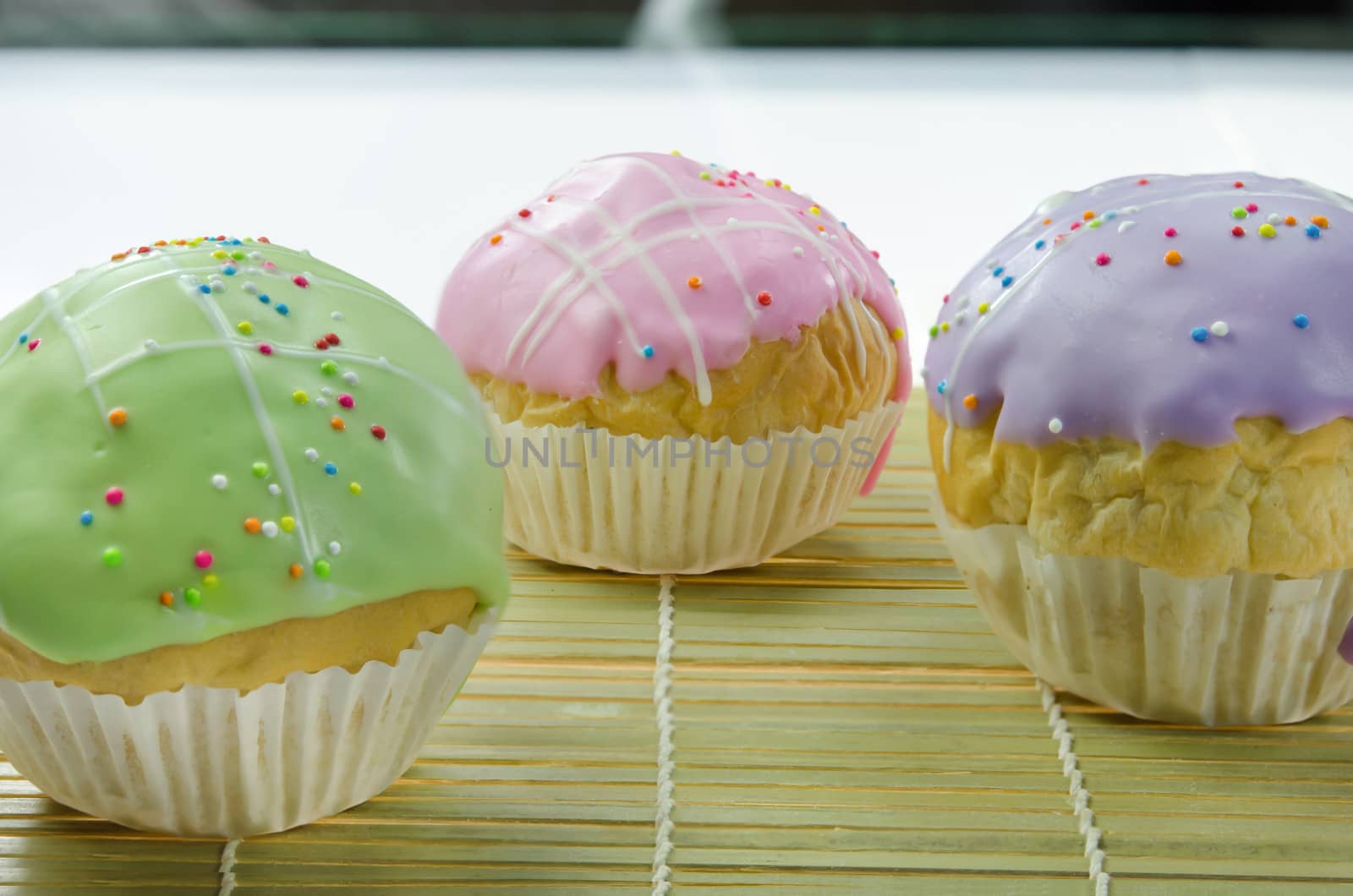 close up  sweet  cupcake with colorful sprinkles on wooden board , delicious dessert