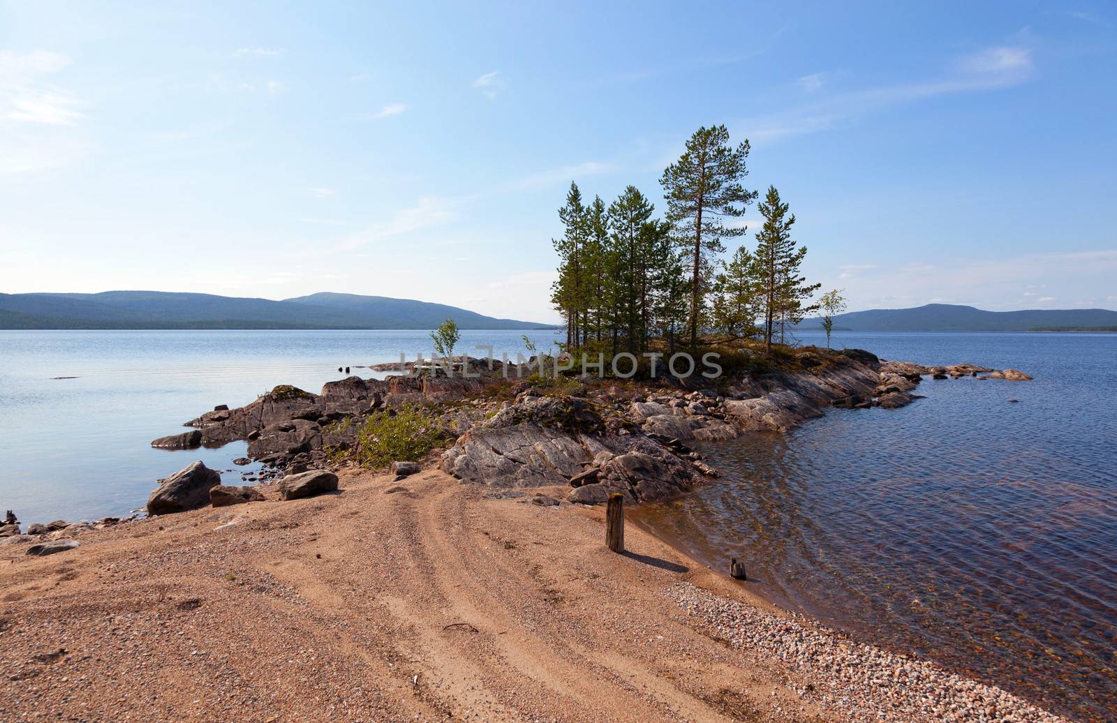 A picturesque lake with a pebble beach in the north of Russia. Tolvand lake. Iovskoe reservoir. Karelia