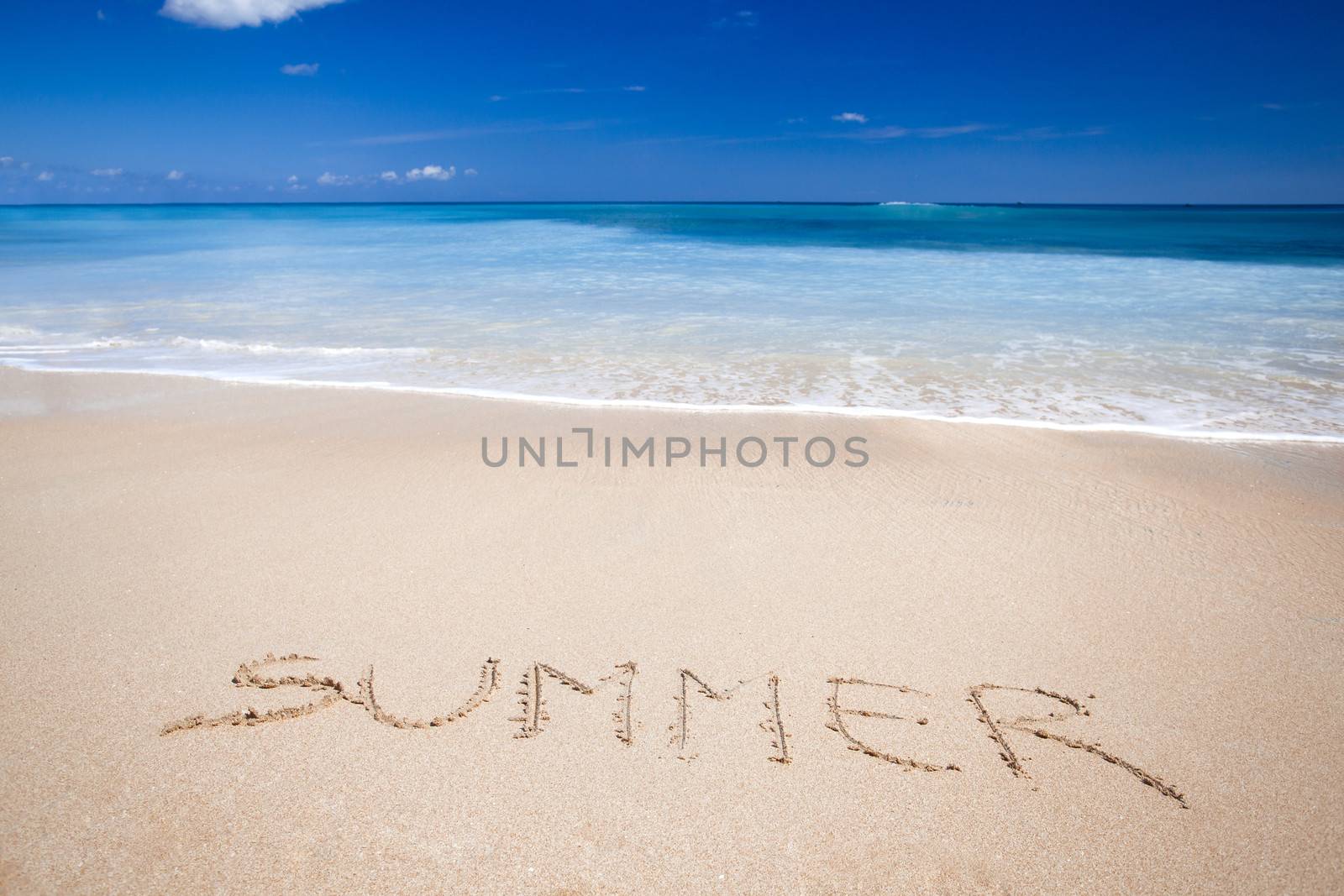 Beautiful tropical beach with the word summer written on the sand