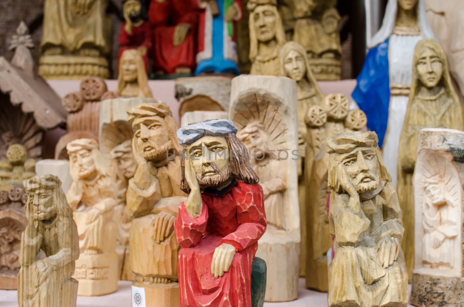 cross sad poor man with hand stay head religion wooden carved figure decoration sell in market fair.