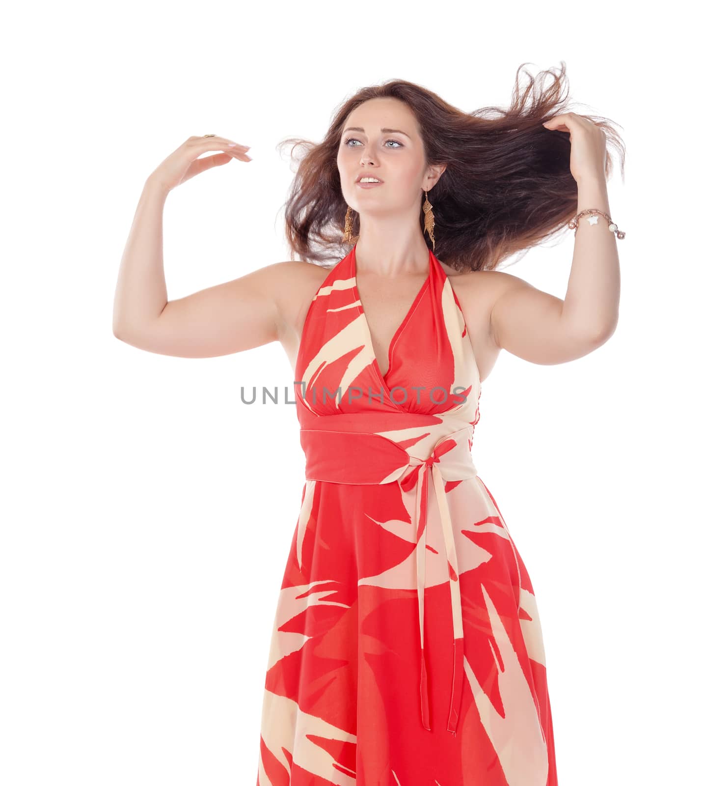 Portrait of a smiling young woman in red dress on white background
