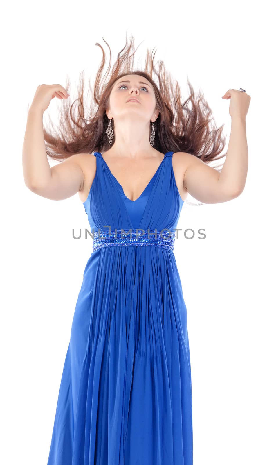 Portrait of a beautiful young woman in blue dress with streaming hair on white background