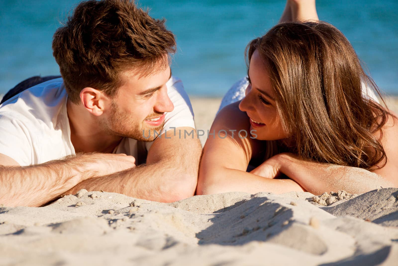 young happy couple in summer holiday vacation summertime beach