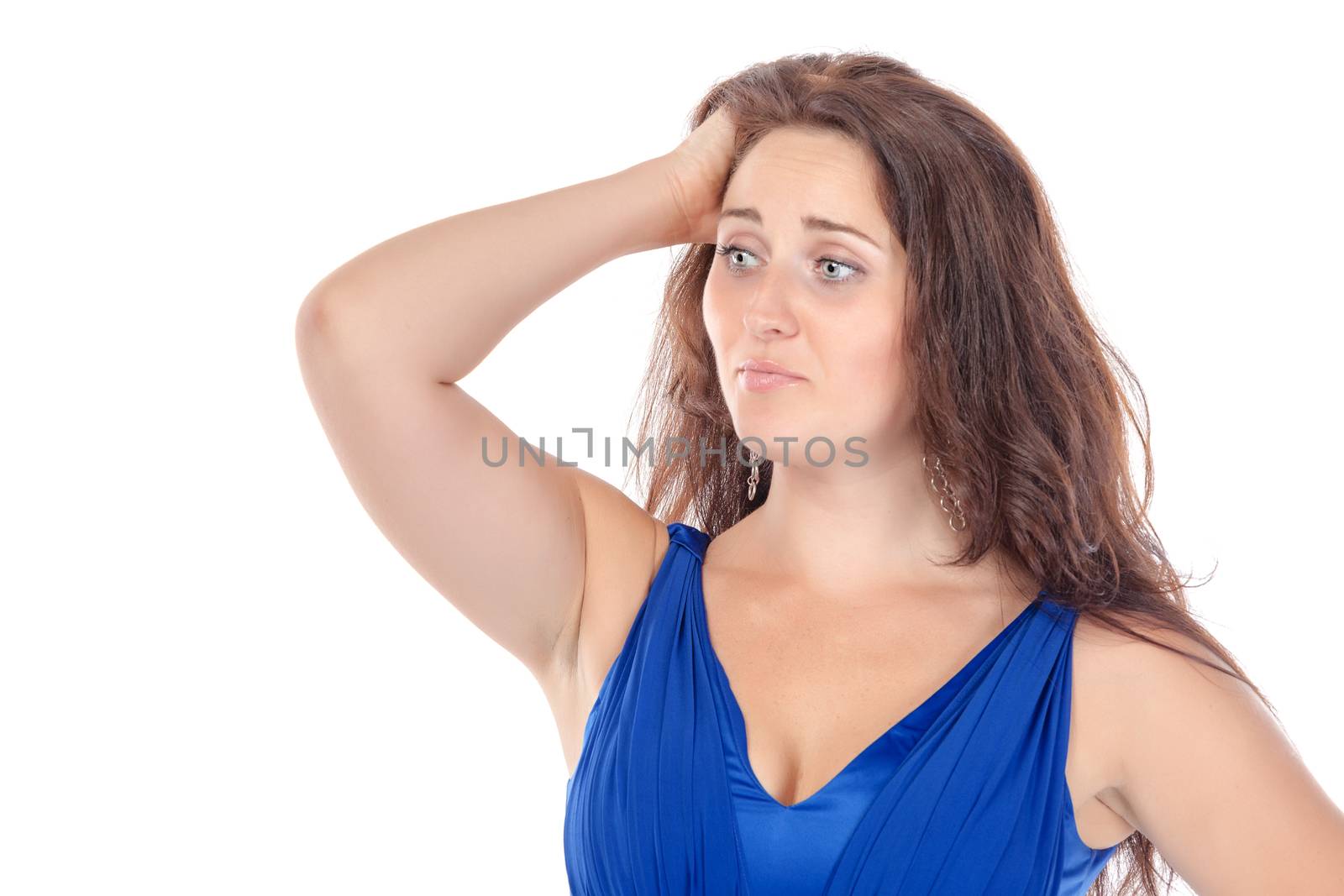 Portrait of a beautiful young woman in blue dress, holding on to her head on white background