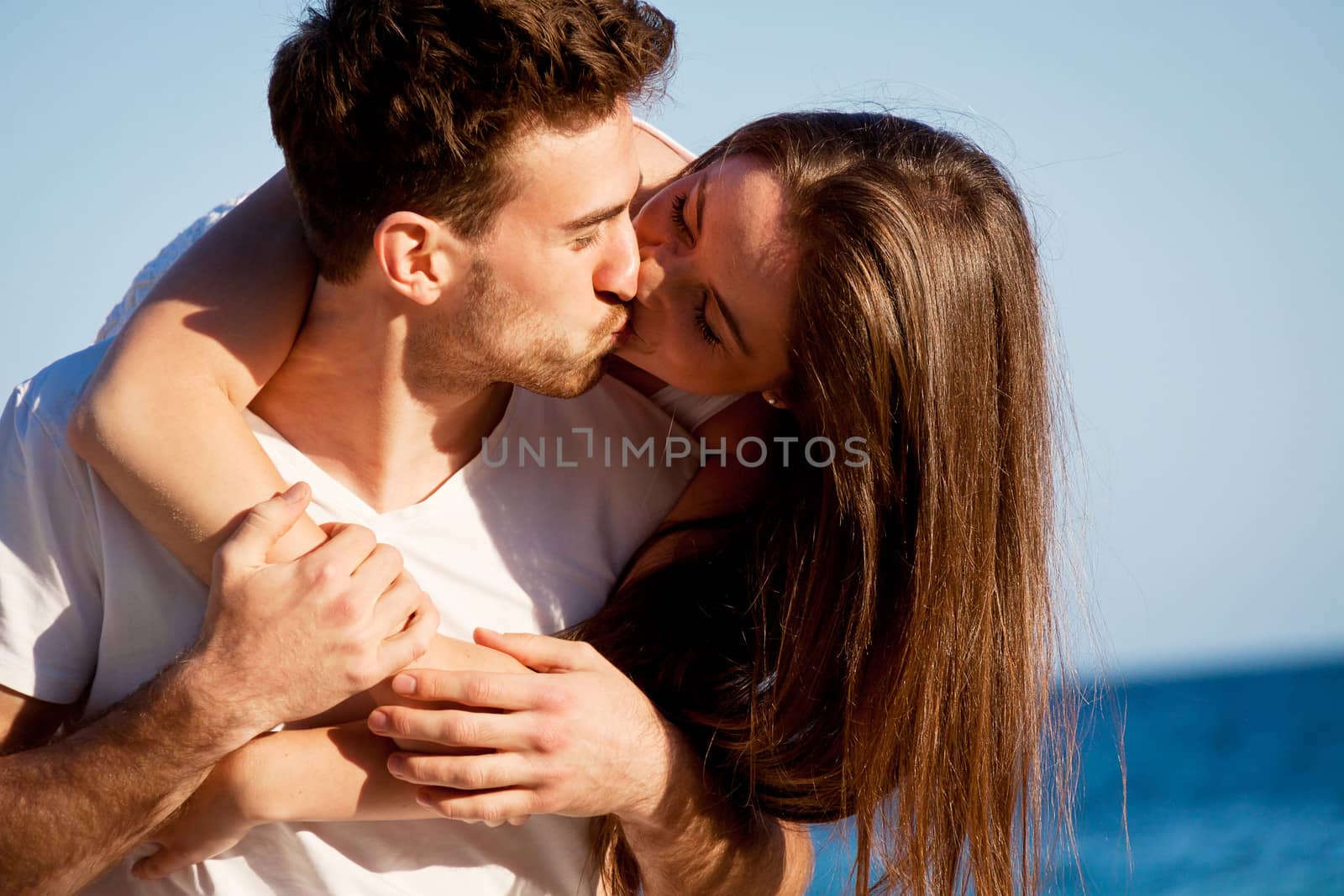 young happy couple in summer holiday vacation summertime beach