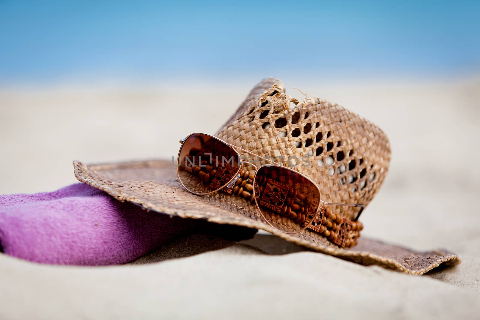 sunprotection objects on the beach in holiday sunglasses hat suncare
