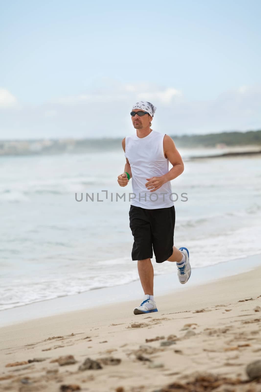 man is jogging on the beach summertime sport fitness run jogger runner