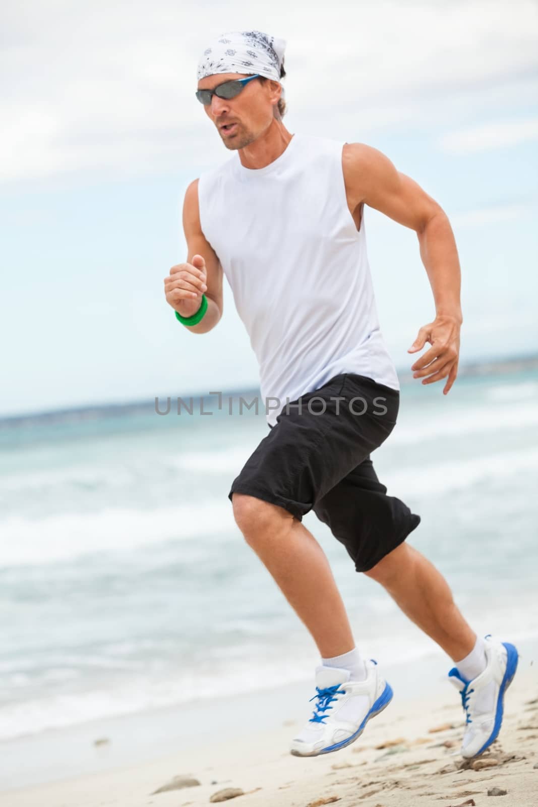 man is jogging on the beach summertime sport fitness run jogger runner