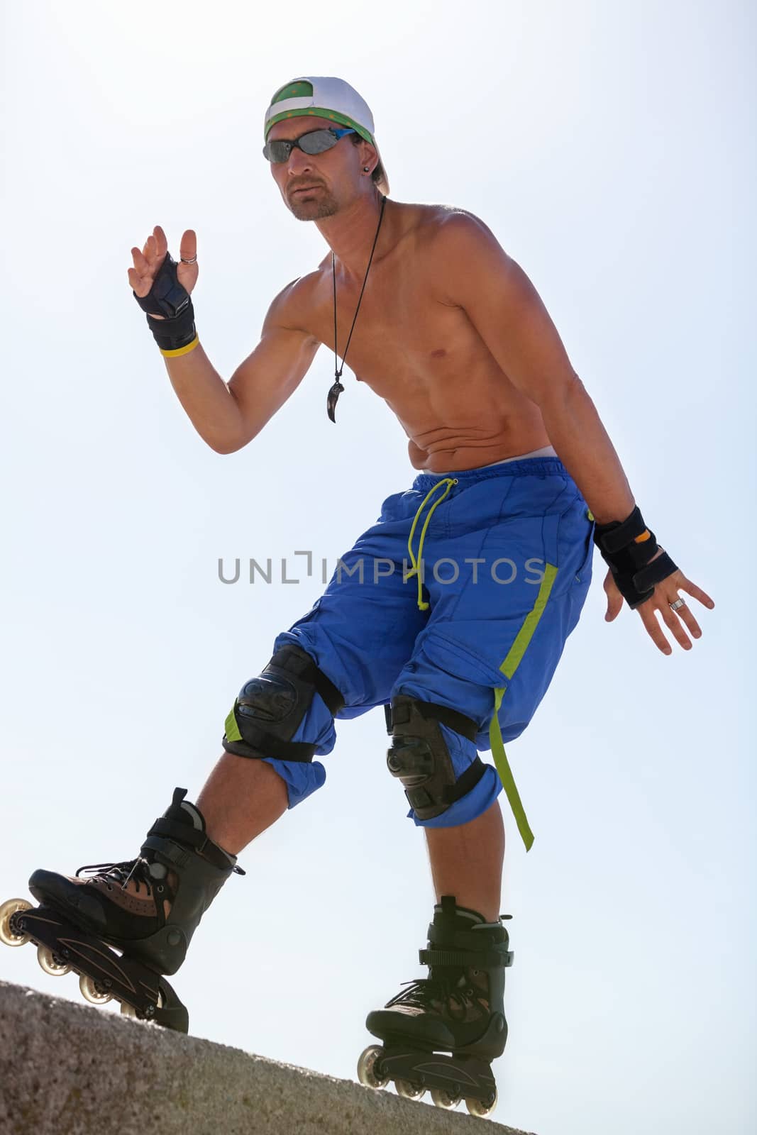 young man with inline skates in summer outdoor rollerblades skater