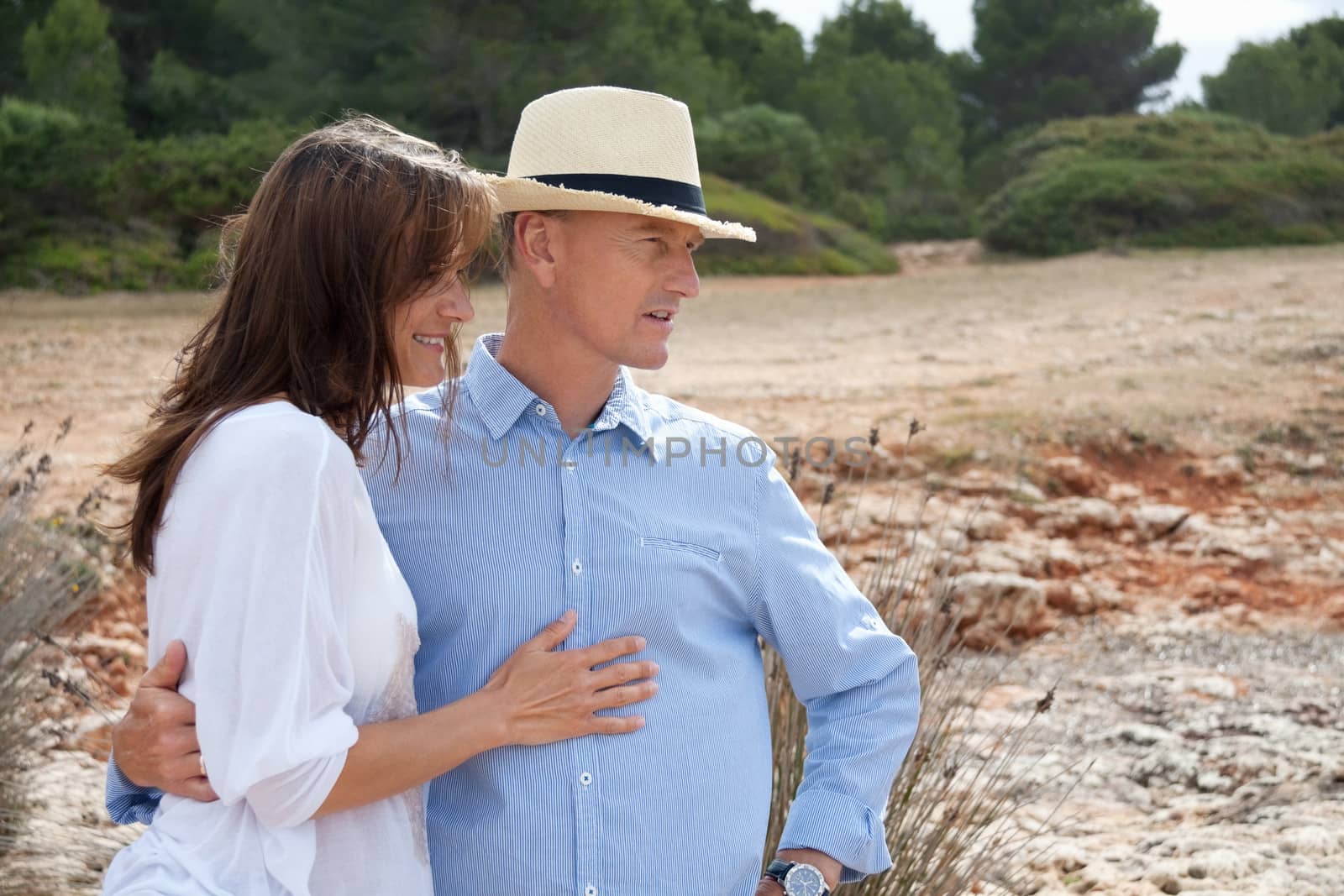 happy adult couple in summertime on beach having fun vacation