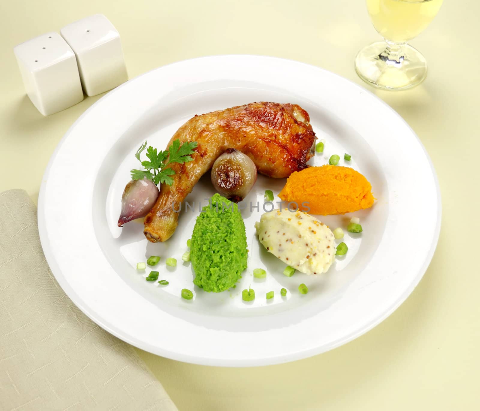 Baked chicken quarter with mashed peas, pumpkin and potato with onions.