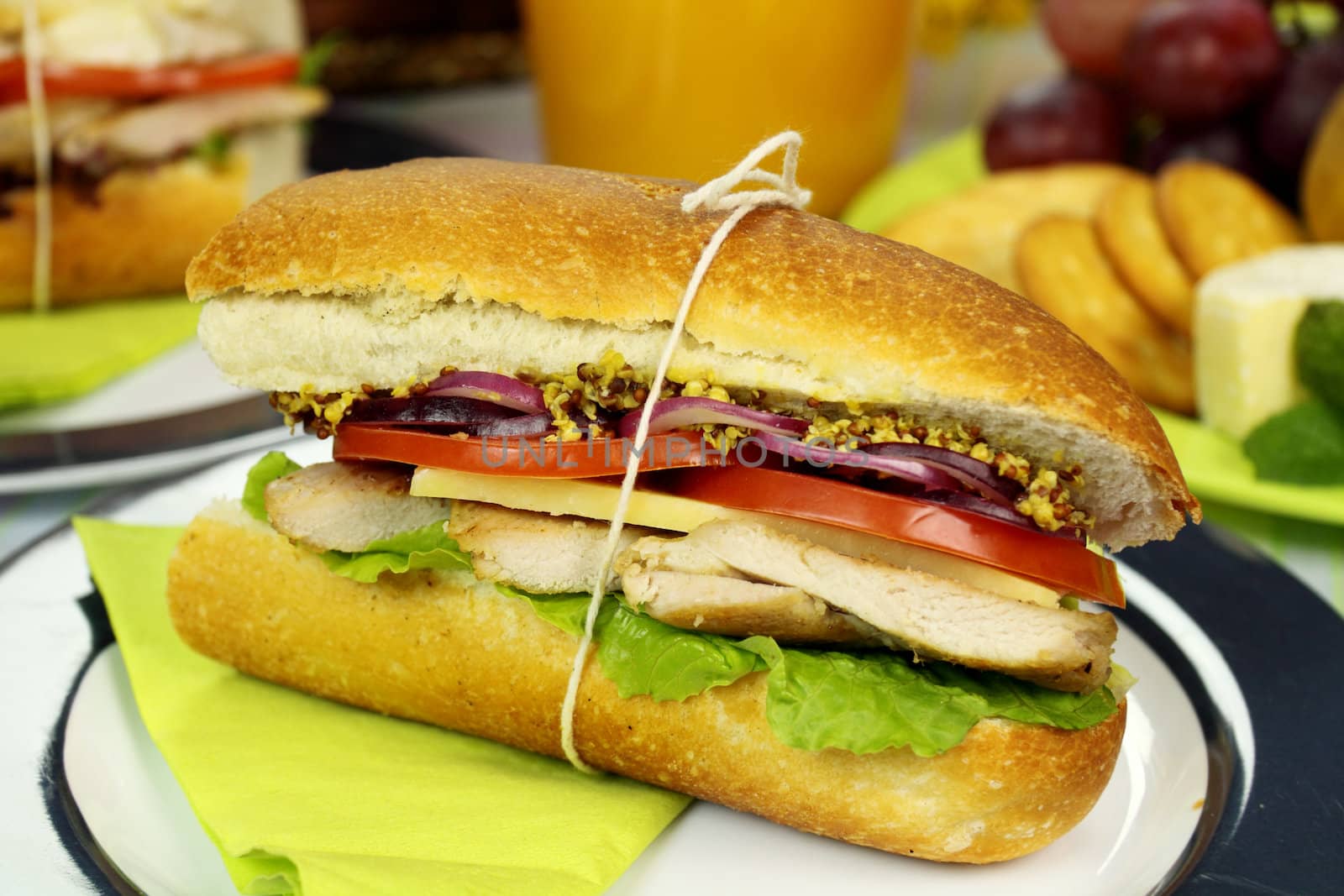 Freshly prepared chicken and salad roll with mustard.