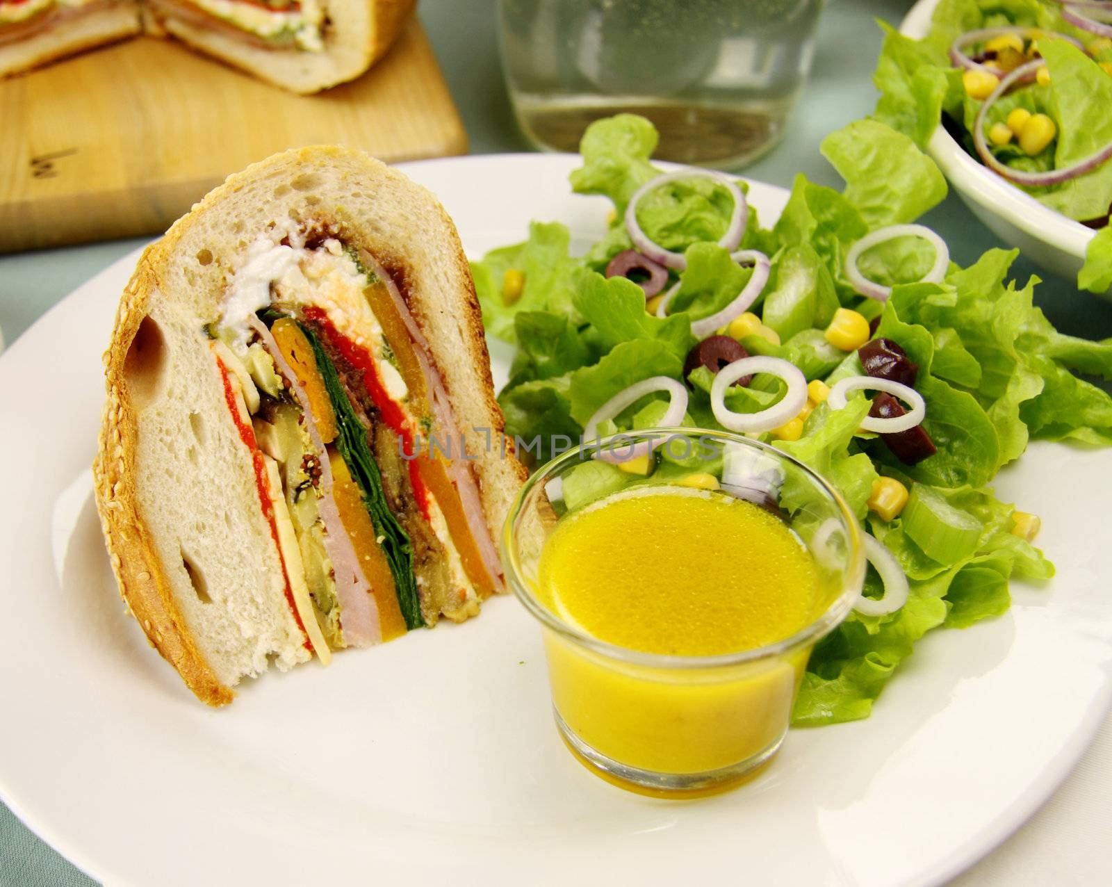 Delicious savory cob loaf filled with ham, salami, aubergine, cottage cheese and vegetables with a corn salad.