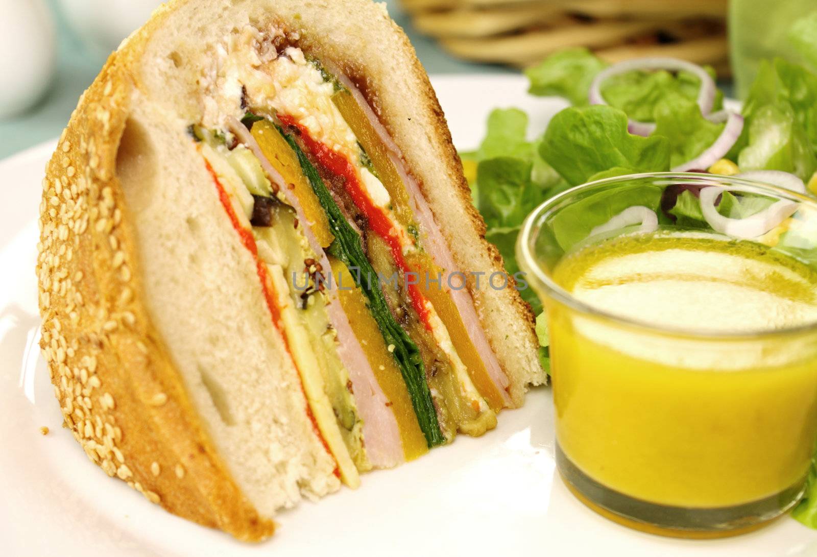 A slice of delicious savory cob loaf filled with ham, salami, aubergine, cottage cheese and vegetables.