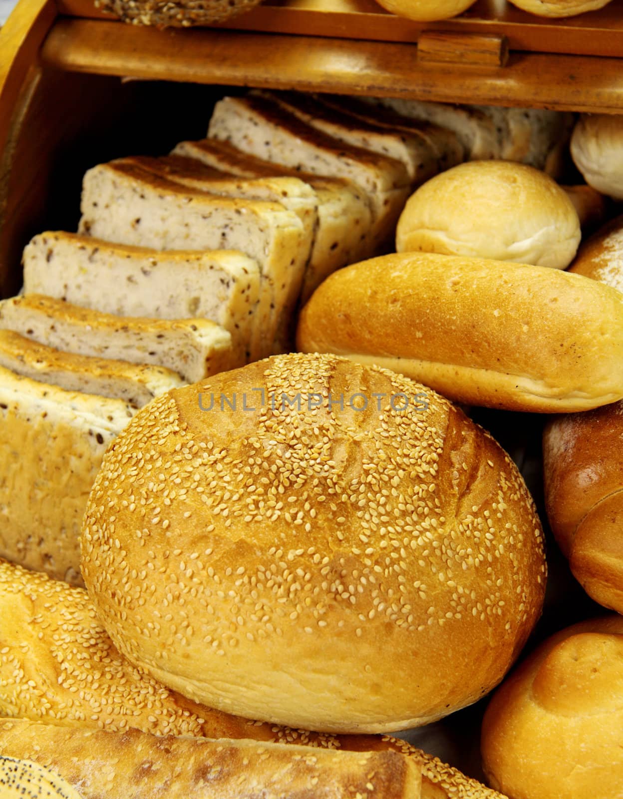 Cob bread loaf amongst a selection of different breads.