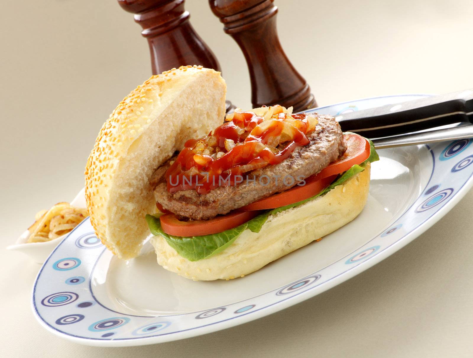 Delicious freshly made hamburger with ketchup and onions.