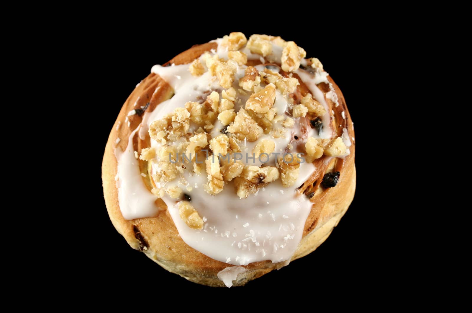 Delicious sweet iced bun with walnuts and coconut.