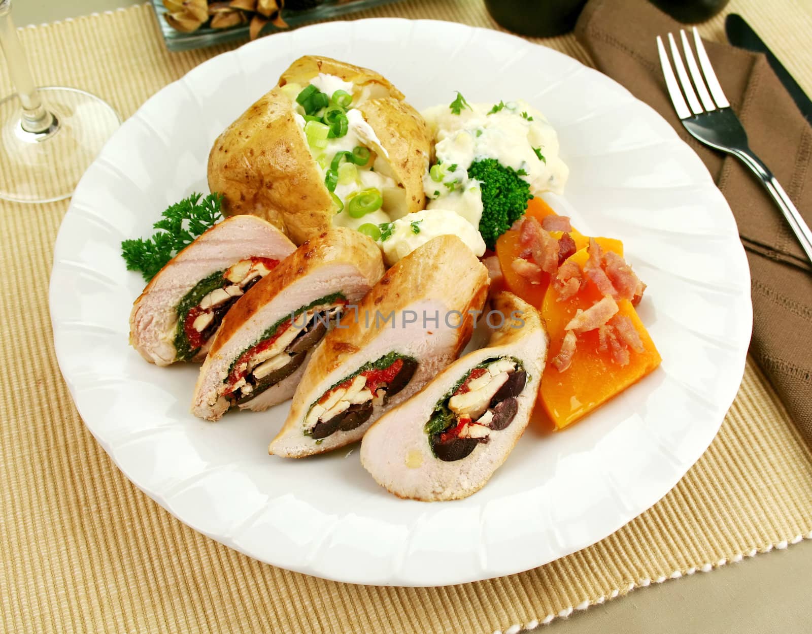 Chicken stuffed with a Mediterranean filling made of spinach, fetta, peppers and olives with vegetables.