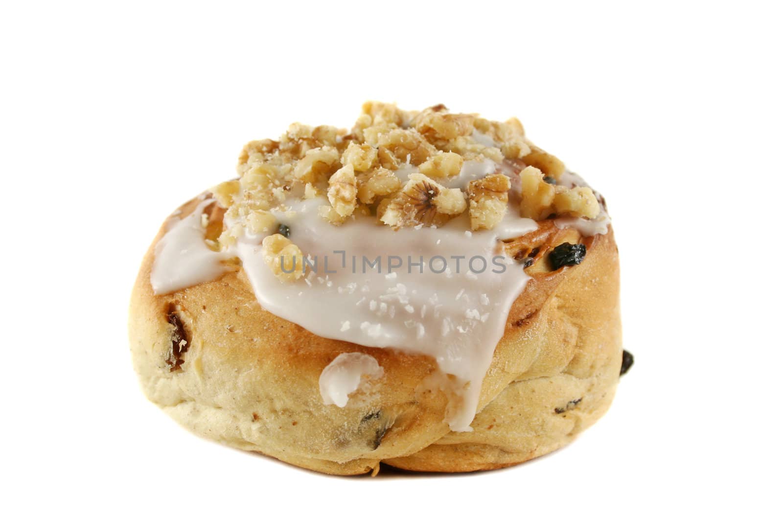 Delicious sweet iced bun with walnuts and coconut.