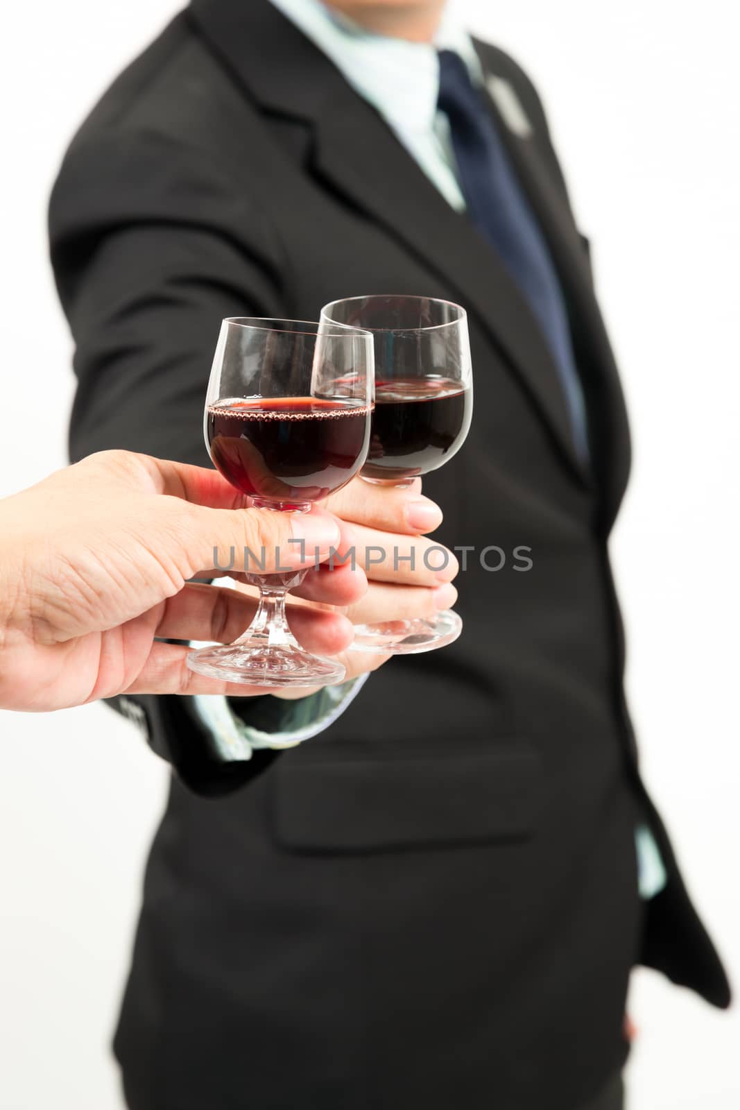 Close-up of human hands cheering up with flutes of wine